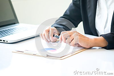 Asia business woman analyzing investment charts on desk. Stock Photo