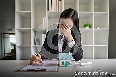 Asia Business woman stress from work investment in real estate, There are financial problem with installments with the Stock Photo