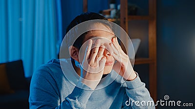 Asia businessman take a break hard work feel tired relax eyes after focus long time type computer in living room at home overtime Stock Photo