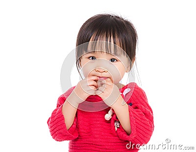 Asia little girl finger touch her lip Stock Photo