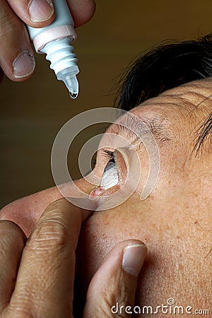 Asia man use medicine eyedropper Stock Photo