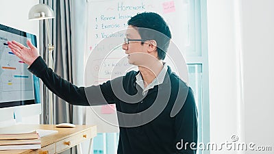 Asia middle-aged male business teacher video conference looking at camera talk by webcam learn teach in online chat at home. Stock Photo