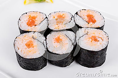 Asia. Spicy rolls with salmon red fish on a white plate on a w Stock Photo