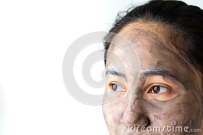 Asia woman applied charcoal mask on her bare face Stock Photo