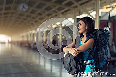 Asia woman with bag backpack, bored waitting time for traveler t Stock Photo