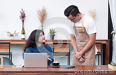 Asia woman customer complaining to waiter about food in cafe res Stock Photo