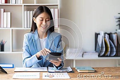 Asian accountants meeting doing accounts payable, assets, capital book value, inventory, liabilities, cost of goods sold. Stock Photo
