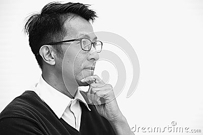 Asian adult with glasses thinking looking far sight Stock Photo