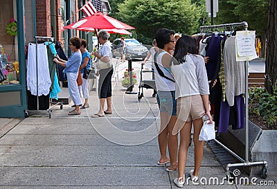 Asian American teenagers going through some used clothing Editorial Stock Photo