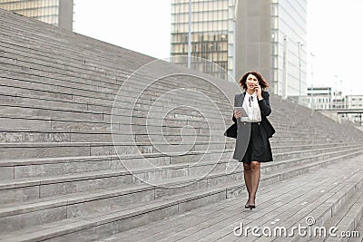 asian appearance business woman walk along stairs speaking Stock Photo