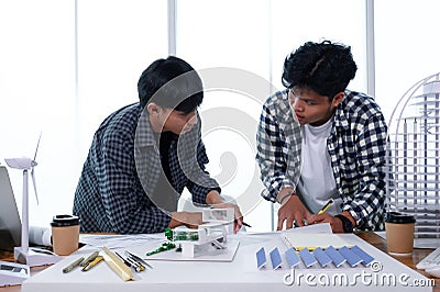 Asian Architect Students Studying Modern House Design and Finding Ways to Utilize Natural Alternative Energy or Use Natural Stock Photo