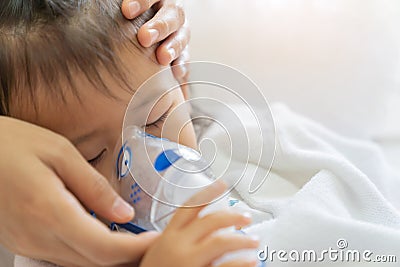 Asian baby girl breathing treatment with mother take care, at room hospital. Stock Photo