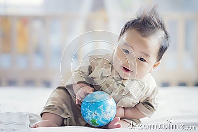 Asian baby in soldier uniform Stock Photo