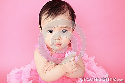 Asian baby on a studio pink background Stock Photo