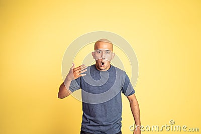 asian bald man opening his mouth with spiciness expression Stock Photo