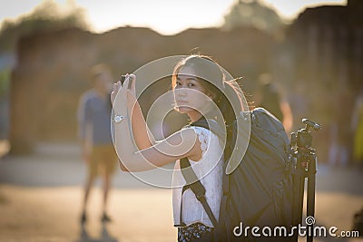 Asian beautiful girl has travel and take a photo at Wat Chaiwatthanaram temple in Ayuthaya, Thailand Stock Photo