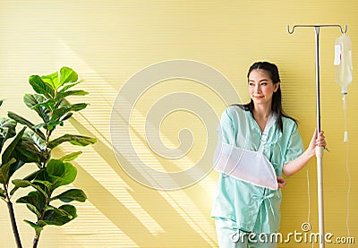 Asian beautiful woman patients standing on yellow background,Happy and smiling,Good attitude,Copy space Stock Photo