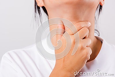 Asian beautiful woman Sore Throat or thyroid gland problem her useing Hand Touching Ill Neck Stock Photo