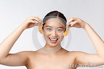 Asian beauty teenager woman care her skin with gold eye masks patches under eyes Stock Photo