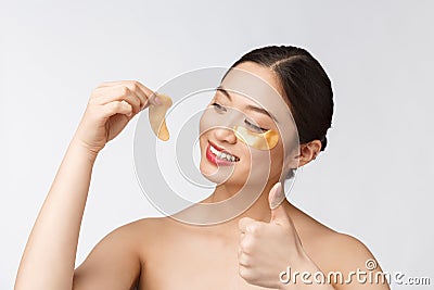 Asian beauty teenager woman care her skin with gold eye masks patches under eyes Stock Photo