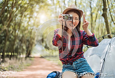 Asian beauty traveler taking photograph by digital cemera while hiking camping. Adventure and leisure activity concept. Happy life Stock Photo