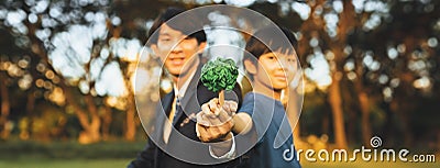 Asian boy and businessman holding paper Tree together. Gyre Stock Photo