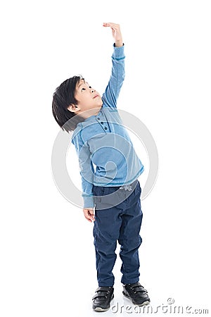 Asian Boy growing tall and measuring himself Stock Photo