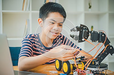 Asian boy learning and studying the work of technology robots.homeschool and science for tech project. playing childhood kids Stock Photo