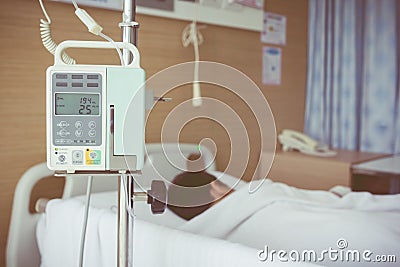 Asian boy lying on sickbed with infusion pump intravenous IV drip. Vintage style. Stock Photo