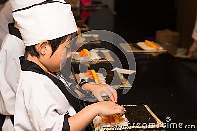 Asian boy making sushi Stock Photo