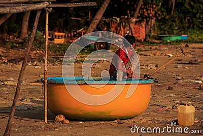 Asian Boy in Red T-shirt Sits in Round Orange Boat Editorial Stock Photo