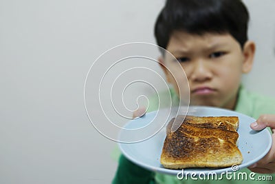 Asian boy show over roasted burnt grilled bread Stock Photo