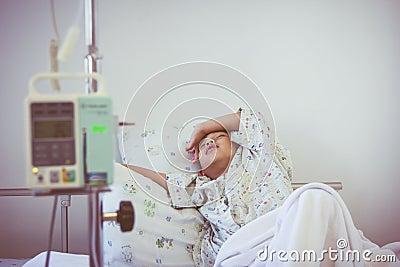 Asian boy sleeping on sickbed with infusion pump intravenous IV Stock Photo