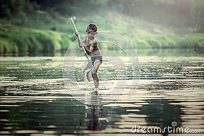 Asian boys fishing at the river Stock Photo