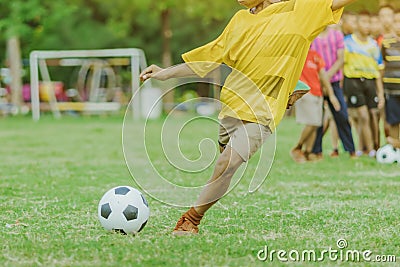 Asian boys practice kicking the ball to score goals Editorial Stock Photo