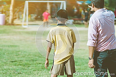 Asian boys practice kicking the ball to score goals Editorial Stock Photo