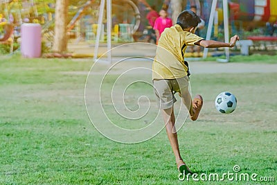 Asian boys practice kicking the ball to score goals Editorial Stock Photo