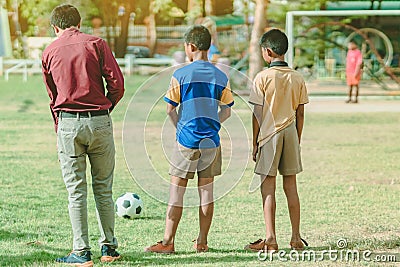 Asian boys practice kicking the ball to score goals Editorial Stock Photo