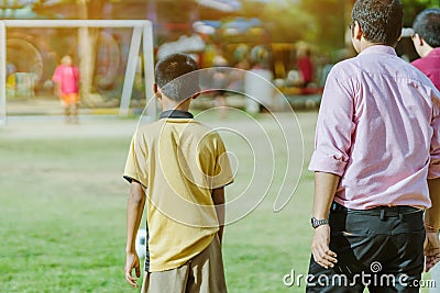 Asian boys practice kicking the ball to score goals Editorial Stock Photo