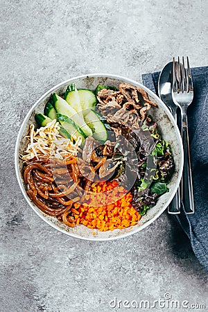 Asian buddha bowl on concrete table background. Delicious food concept Stock Photo