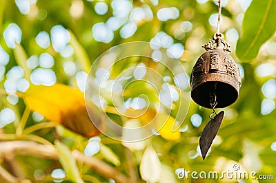 Asian Buddhism bronze antique bell with green leaves background Stock Photo