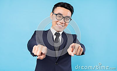 Asian buisnessman wearing suit pointing on blue background Stock Photo