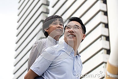 Asian business father and son confidence child want to be like a his dad parent and young boy standing in city with cityscape Stock Photo