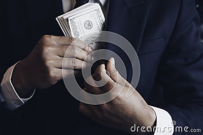 Asian business individual who owns the business sign personally sealing the deal with receiving a bribe money.The concept of Stock Photo