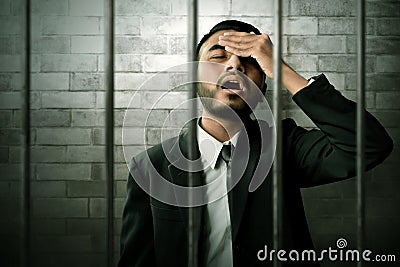 Asian business man in prison Stock Photo