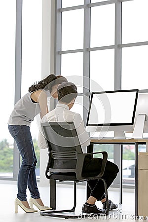 Asian business people sitting on chair in modern office and using computer, white screen and blank mock up of any content will Stock Photo