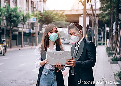 Asian Business People Working and Surveying Outdoor Location for New Business ,They are Wearing Protective Mask to Prevent Flu and Stock Photo