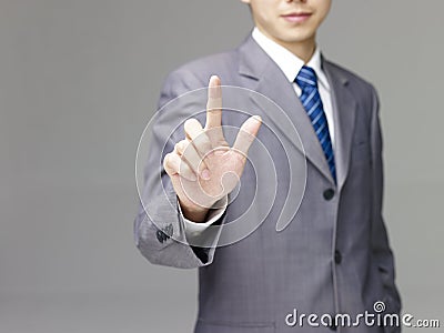 Asian business person pushing a virtual button Stock Photo