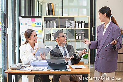 Asian business team consists of marketing staff. accountant and financial officer Help each other analyze company profits using Stock Photo