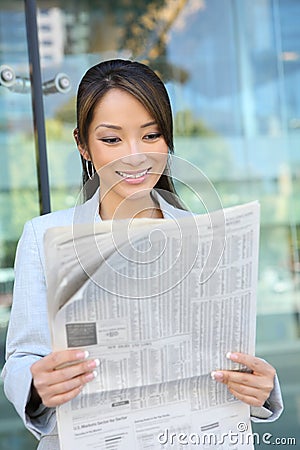 Asian Business Woman Reading Newspaper Stock Photo